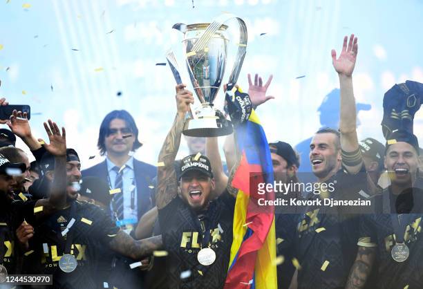 Cristian Arango of Los Angeles FC ifts the championship trophy as he celebrates with teammates during the 2022 MLS Cup Final at Banc of California...
