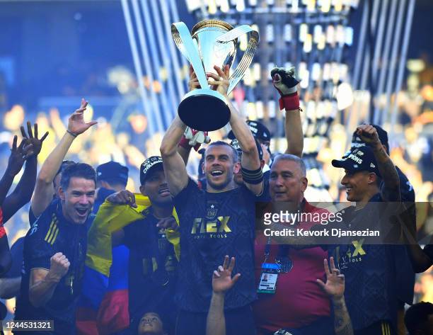 Gareth Bale of Los Angeles FC lifts the championship trophy as he celebrates with teammates during the 2022 MLS Cup Final at Banc of California...