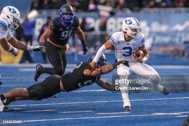 Linebacker DJ Schramm of the Boise State Broncos tries to drag down quarterback Jaren Hall of the BYU Cougars during first half action at Albertsons...