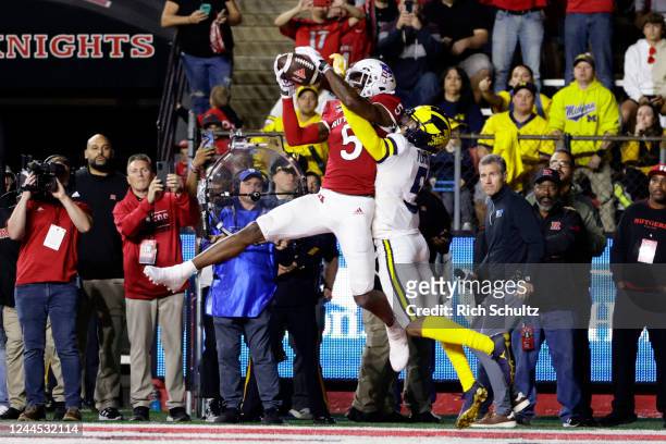 Sean Ryan of the Rutgers Scarlet Knights makes a catch in the end zone for a touchdown as DJ Turner of the Michigan Wolverines defends during the...