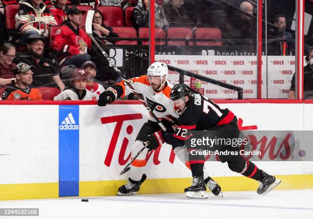 Thomas Chabot of the Ottawa Senators body-checks Tanner Laczynski of the Philadelphia Flyers at Canadian Tire Centre on November 5, 2022 in Ottawa,...