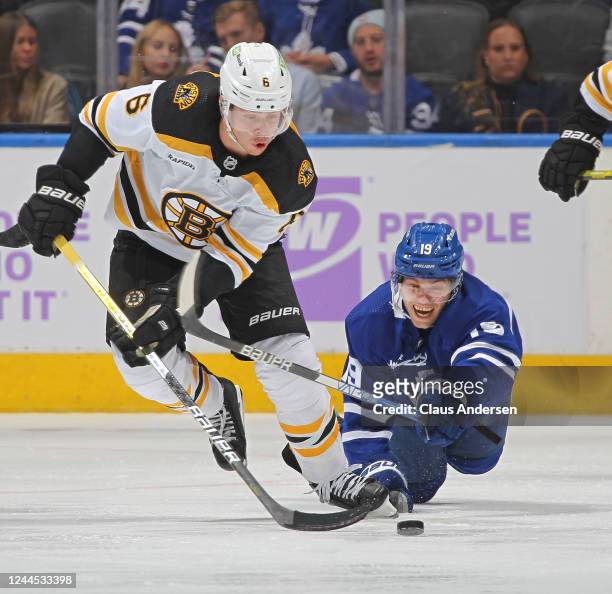 Mike Reilly of the Boston Bruins skates away with the puck from a falling Calle Jarnkrok of the Toronto Maple Leafs during an NHL game at Scotiabank...