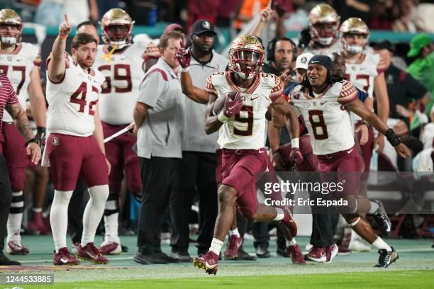 Lawrance Toafili of the Florida State Seminoles runs down the sideline during the second quarter against the Miami Hurricanes at Hard Rock Stadium on...