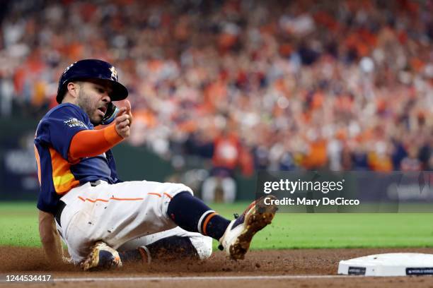 Jose Altuve of the Houston Astros slides safely into third base during Game 6 of the 2022 World Series between the Philadelphia Phillies and the...