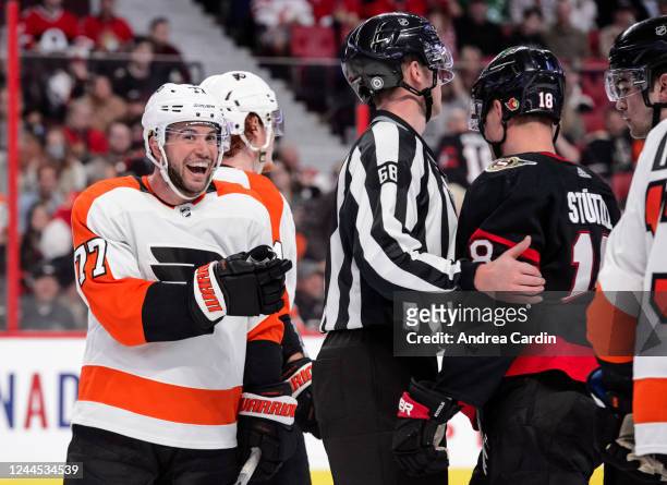 Tony DeAngelo of the Philadelphia Flyers has a laugh after being separated from Tim Stützle of the Ottawa Senators at Canadian Tire Centre on...