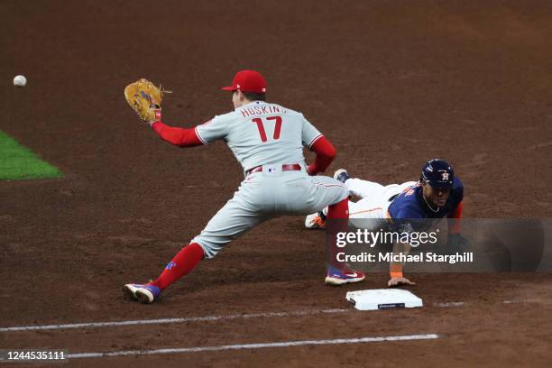 Jeremy Peña of the Houston Astros dives back into first base in the fourth inning during Game 6 of the 2022 World Series between the Houston Astros...