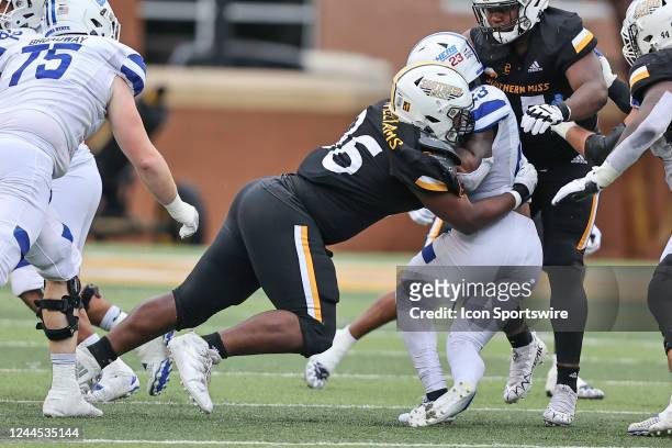 Southern Miss Golden Eagles defensive lineman Jalen Williams stops Georgia State Panthers running back Marcus Carroll for a loss during a college...