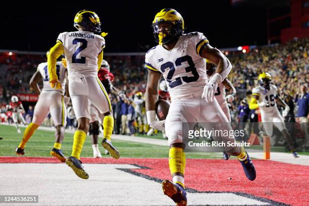 Michael Barrett of the Michigan Wolverines scores a touchdown after intercepting a pass against the Rutgers Scarlet Knights during the third quarter...