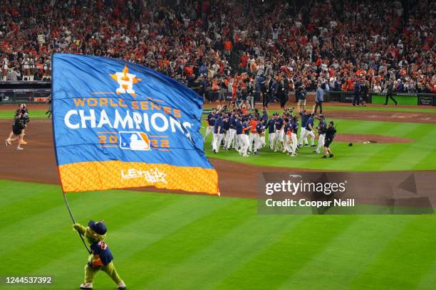 Houston Astros mascot Orbit waves a World Series Champions flag as members of the Houston Astros celebrate after taking Game 6 against the...