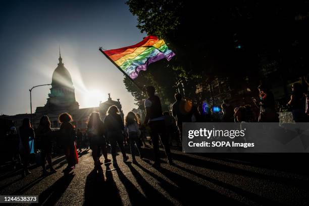 An attendee holds a rainbow flag in front of the Congress building during the annual Pride Parade. Demonstrators marched from Plaza de Mayo square to...