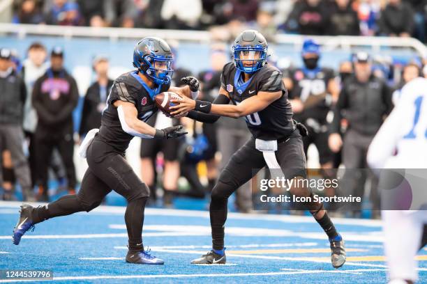 Boise State Broncos quarterback Taylen Green hands the football off to Boise State Broncos running back George Holani during a college football game...