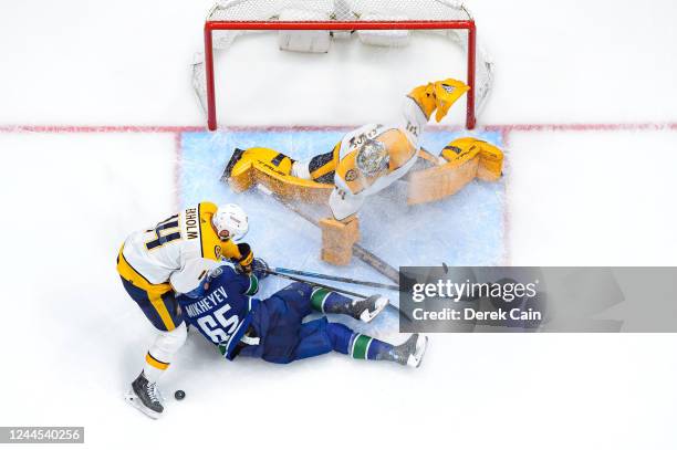 Mattias Ekholm of the Nashville Predators checks Ilya Mikheyev of the Vancouver Canucks to the ice during the second period of their NHL game at...