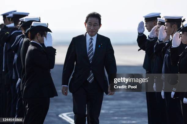 Japanese Prime Minister Fumio Kishida is saluted by members of the Japan Maritime Self-Defence Force during an International Fleet Review...