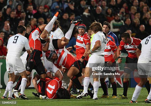 Kosuke Endo of Japan lifts Aurelien Rougerie of France during the IRB 2011 Rugby World Cup Pool A match between France and Japan at North Harbour...