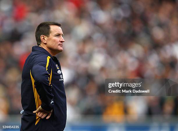 John Worsfold coach of the Eagles watches Collingwood celebrate their win in the AFL First Qualifying match between the Collingwood Magpies and the...