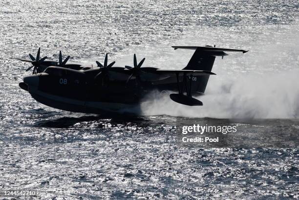 The Japan Maritime Self-Defence Force ShinMaywa US-2 seaplane amphibious aircraft lands on sea during an International Fleet Review commemorating the...