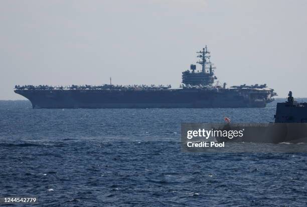 The USS Ronald Reagan, a Nimitz-class nuclear-powered super carrier, participates in an International Fleet Review commemorating the 70th anniversary...