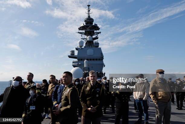 Military personnel and guests watch an International Fleet Review commemorating the 70th anniversary of the founding of the Japan Maritime...