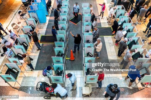 Clark County poll workers work quickly to usher in the long lines of voters wanting to vote on the last day of early voting at the Galleria Sunset...