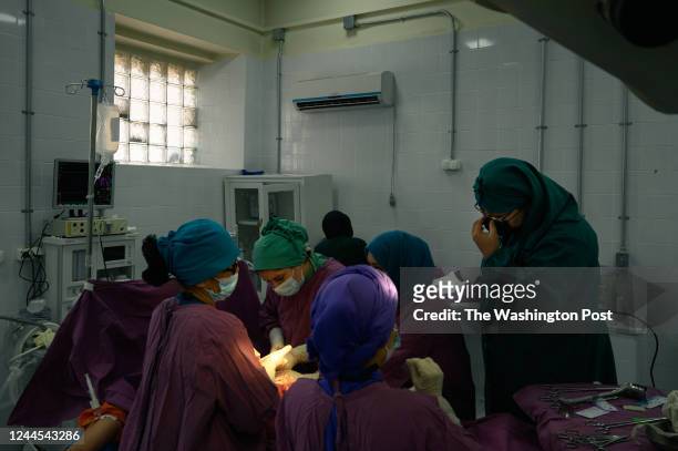 Two residents perform an abdominal hysterectomy at the Rabia Balkhi public womens hospital, one of Kabuls busiest, on October 23, 2022. Despite the...