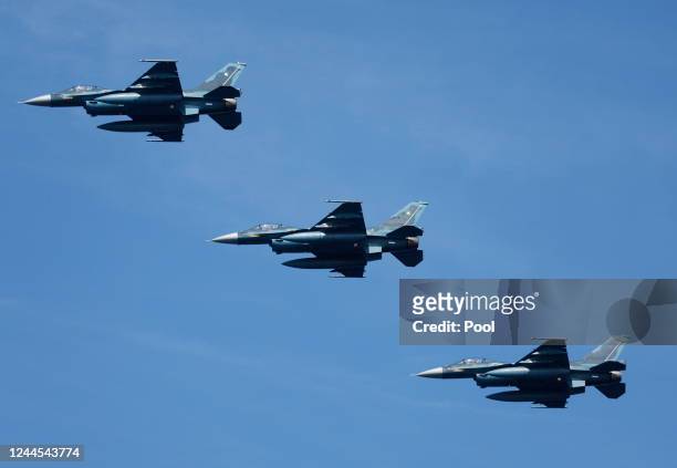 The Japan Air Self-Defense Force Mitsubishi F-2 fighters fly past during an International Fleet Review commemorating the 70th anniversary of the...