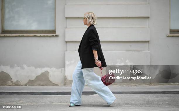 Karin Teigl wearing Bottega Veneta heels, Chanel bag, Closed jeans, Valentino shades, Skims bra, Zara blazer and Swarovski chain on May 31, 2020 in...