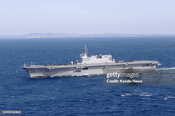 Photo taken by a Kyodo News reporter on board a Japan Maritime Self-Defense Force helicopter shows the MSDF destroyer Izumo taking part in an...