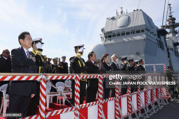 Japan's Prime Minister Fumio Kishida looks out from the Japanese ship JS Izumo as he inspects the "International Fleet Review", held by Japan's...