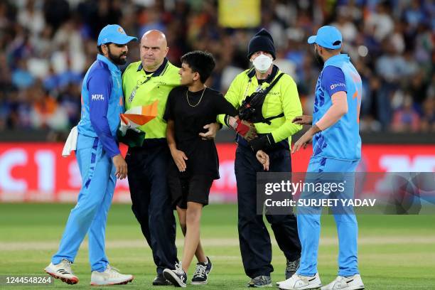 India's Captain Rohit Sharma and Mohammed Shami talk to the security official for a fan during the ICC men's Twenty20 World Cup 2022 cricket match...