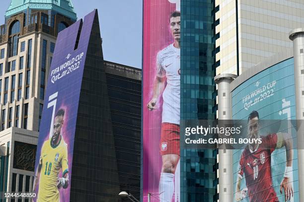 Large pictures of Brazil's forward Neymar Jr , Poland's Robert Lewandowski , and Serbia's captain Dusan Tadic adorn buildings in Doha on November 6...
