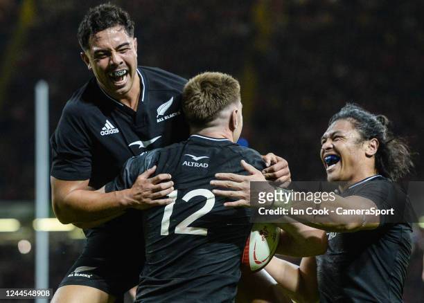 New Zealand's Jordie Barrett celebrates with his with team-mates New Zealand's Anton Lienert-Brown and Caleb Clarke during the Autumn International...