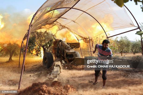 Syrian opposition fighters fire artillery at pro-government forces from a position in the northwestern Idlib province, on November 6 in retaliation...