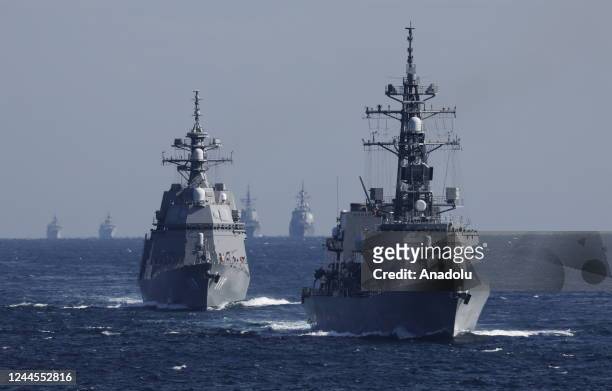 Japan's Maritime Self-Defense Force destroyer Hyuga leads the JMSDF fleet during an International Fleet Review commemorating the 70th anniversary of...