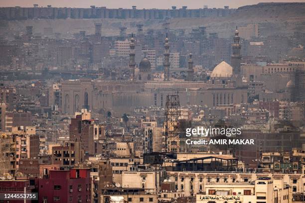 This picture taken on November 1, 2022 shows a view of the skyline of Egypt's capital Cairo, showing a view of the Mosque-Madrassa of Sultan Hassan ,...