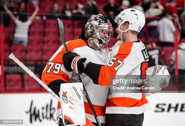 Carter Hart and Wade Allison of the Philadelphia Flyers celebrate their 2-1 win against the Ottawa Senators at Canadian Tire Centre on November 5,...