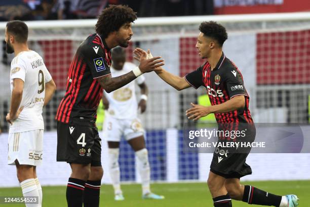 Nice's French midfielder Sofiane Diop celebrates with Nice's Brazilian defender Dante after teammate Nice's French forward Gaetan Laborde scores a...