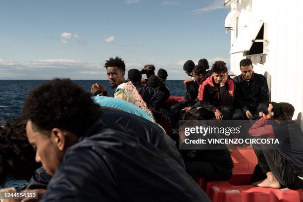 Migrants sit on the deck of the rescue ship "Ocean Viking" of European maritime-humanitarian organization "SOS Mediterranee" on November 6 in the...