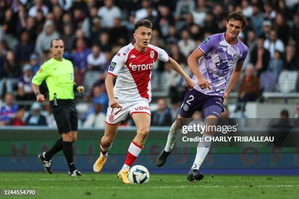 Monaco's Russian midfielder Aleksandr Golovin runs with the ball ahead of Toulouse's Danish defender Rasmus Nicolaisen during the French L1 football...