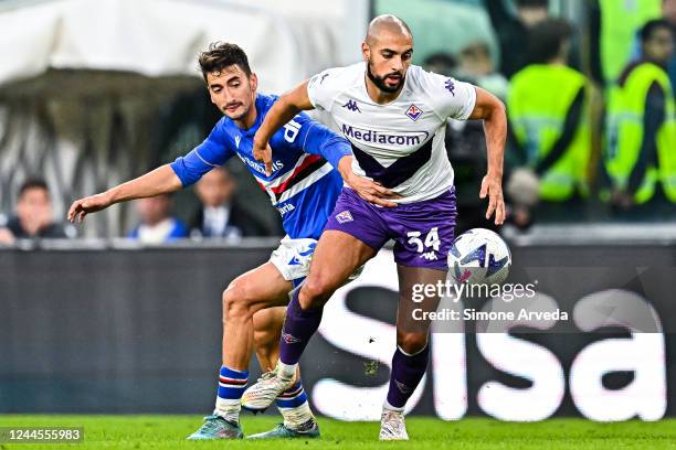 Filip Djuricic of Sampdoria and Sofyan Amrabat of Fiorentina vie for the ball during the Serie A match between UC Sampdoria and ACF Fiorentina at...