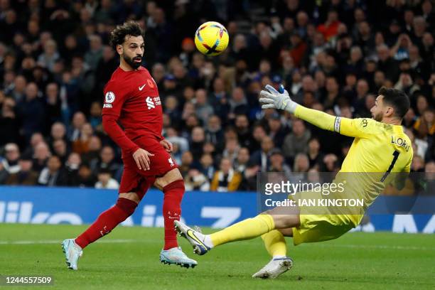 Liverpool's Egyptian striker Mohamed Salah scores his team's second goal past Tottenham Hotspur's French goalkeeper Hugo Lloris during the English...