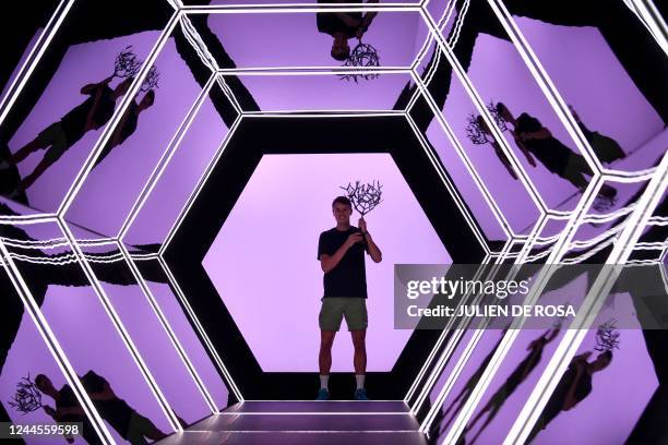 Denmark's Holger Rune celebrates with the trophy after winning his men's singles final tennis match against Serbia's Novak Djokovic, on day 7 of the...