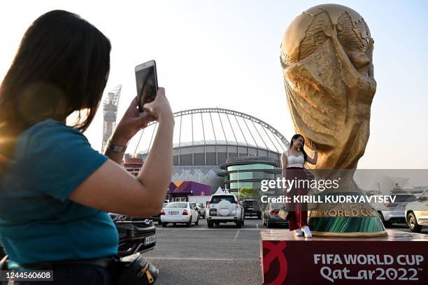 Woman poses in front of the Khalifa Stadium in Doha on November 6 ahead of the Qatar 2022 FIFA World Cup football tournament.