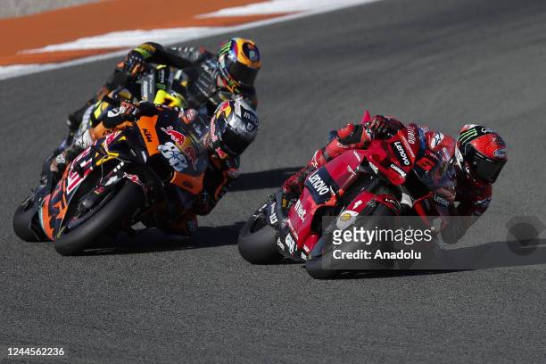 Francesco Bagnaia of Ducati Lenovo Team and Miguel Oliveira of Red Bull KTM Factory Racing compete in the 20th and final leg of the Spanish Grand...