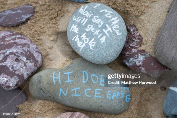 Close-up of stones left at a memorial in tribute to Dobby, a fictional house elf from the Harry Potter fantasy novels and films, at Freshwater West...