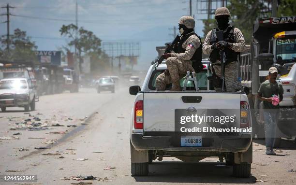 Haiti police on patrol keep their eyes on traffic during a stop at a police checkpoint in Tabarre, near the U.S. Embassy, just east of metropolitan...