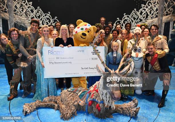 Sara Cox and the cast of Frozen The Musical present Pudsey the Bear with a check for £50,000 following the Gala Performance of "Frozen The Musical"...