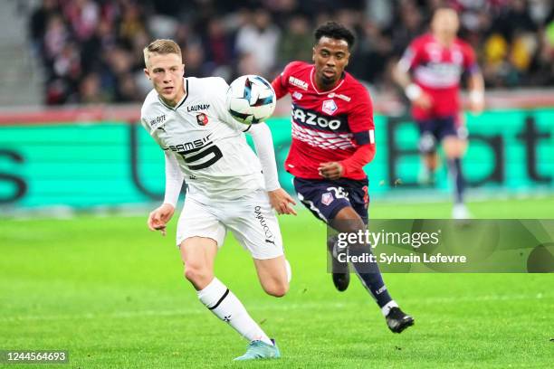 Adrien Truffert of Stade Rennais competes for the ball with Adilson Angel abreu de Almeida Gomes of Lille OSC during the Ligue 1 match between Lille...