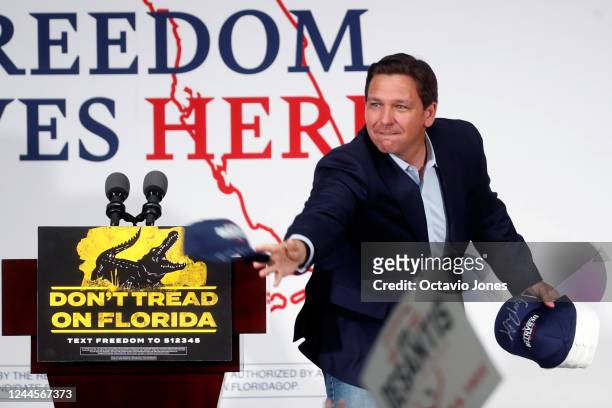Republican incumbent Florida Gov. Ron DeSantis tosses hats before giving a campaign speech at the SCC Community Hall on November 6, 2022 in Sun City...