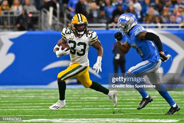 Green Bay Packers running back Aaron Jones runs wide trying to avoid Detroit Lions cornerback Mike Hughes during the Detroit Lions versus the Green...