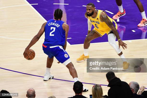 LeBron James of the Los Angeles Lakers plays defense on Kawhi Leonard of the LA Clippers during the game on October 20, 2022 at Crypto.Com Arena in...